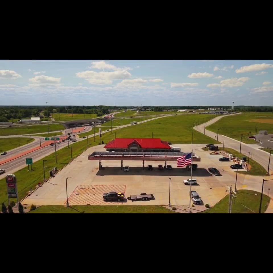 Aerial view of a gas station with a fuel canopy and convenience store